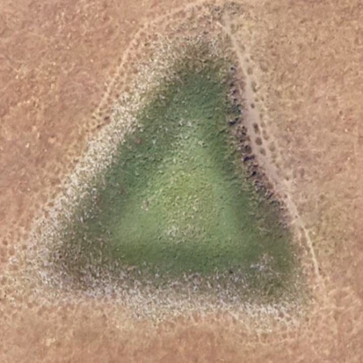 Overlay of the cipher triangle against the triangular ground feature near the decoded endpoint.